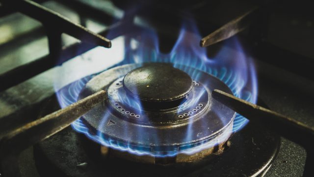 Blue flames of a gas stove illustrating the gas crisis