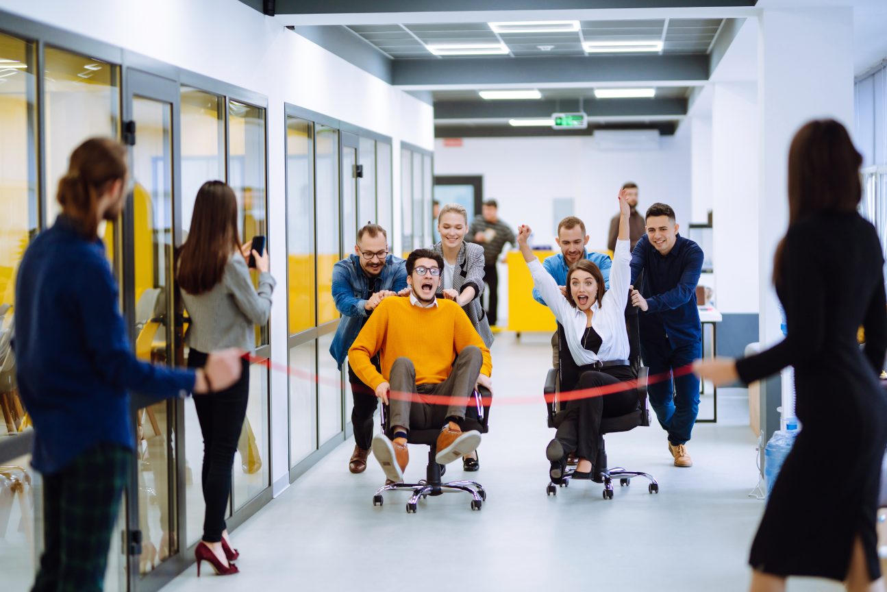 Office team plays a game of chair races to keep their spirits up.