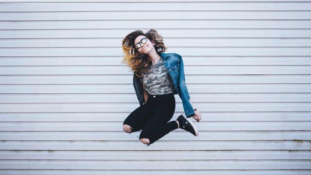 A woman jumping for joy illustrating toxic positivity