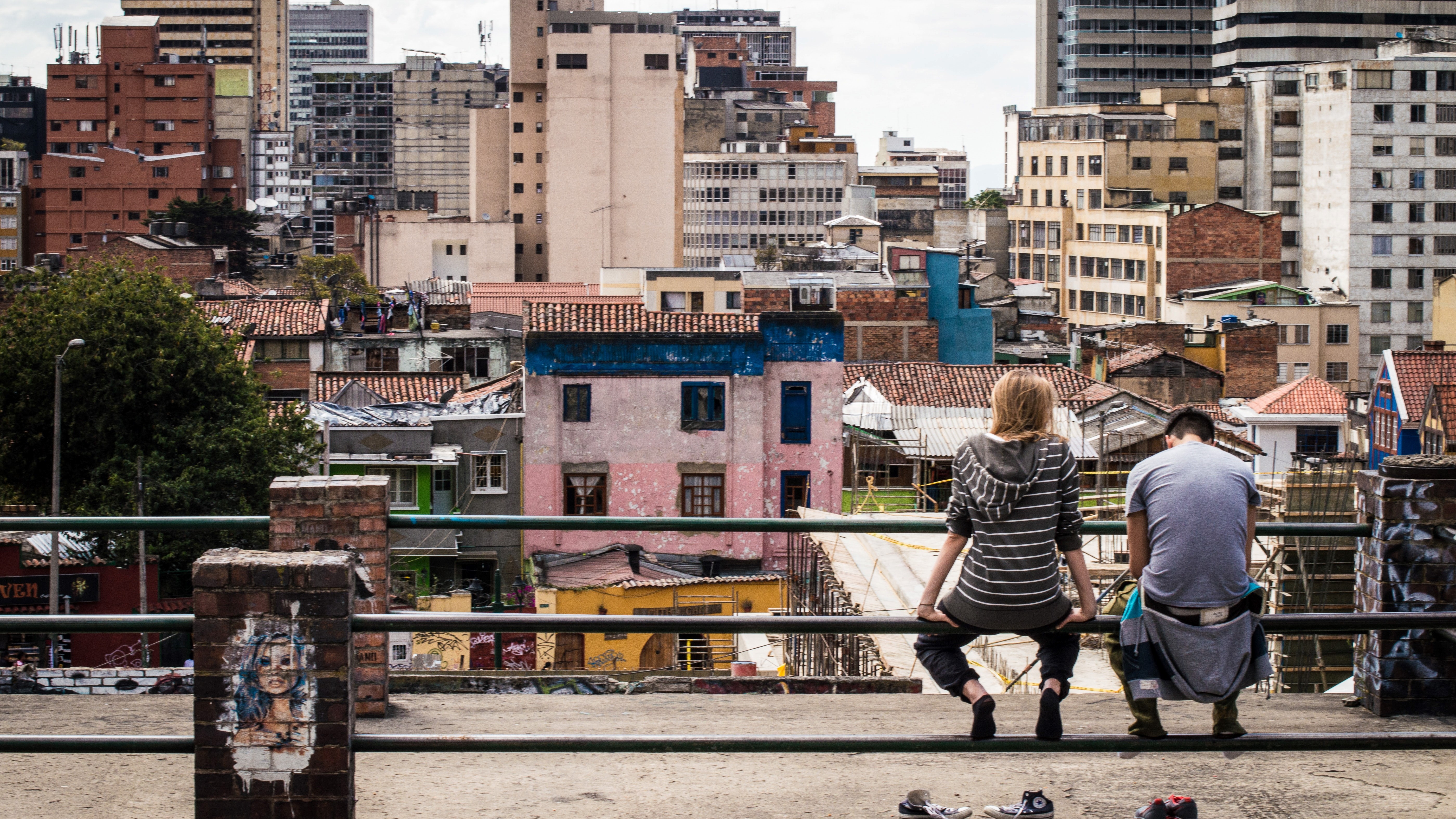 Are we close to the end of poverty? Two people look over a neighborhood in Bogota.