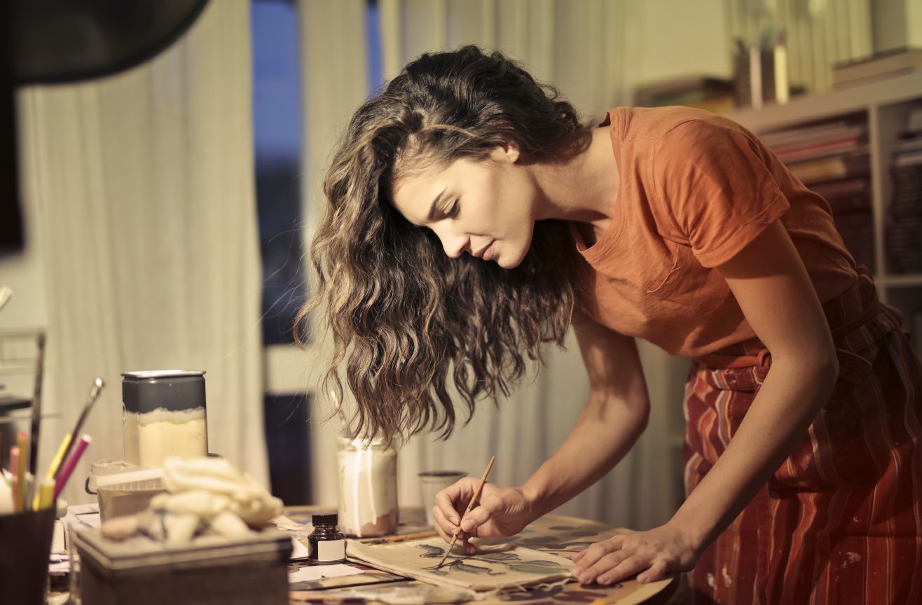 A woman paints as part of her creative habit.