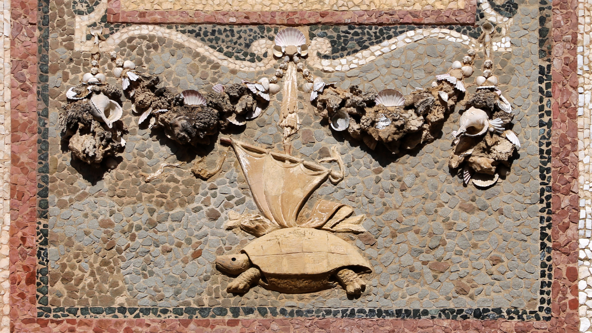 A mosaic at the Buontalenti Grotto features a turtle with a sail on its carapace symbolizing festina lente.