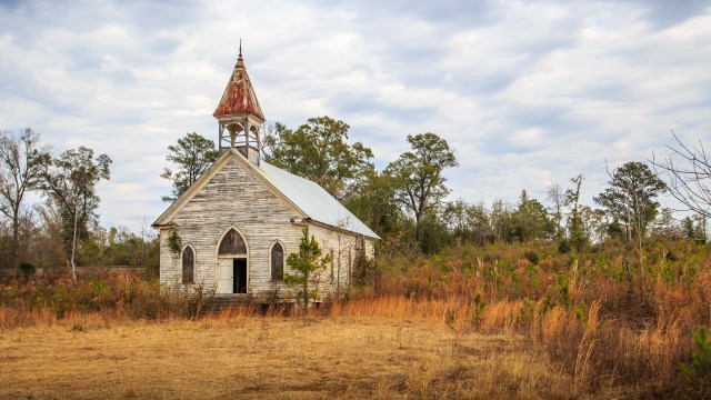 An abandoned church in a field