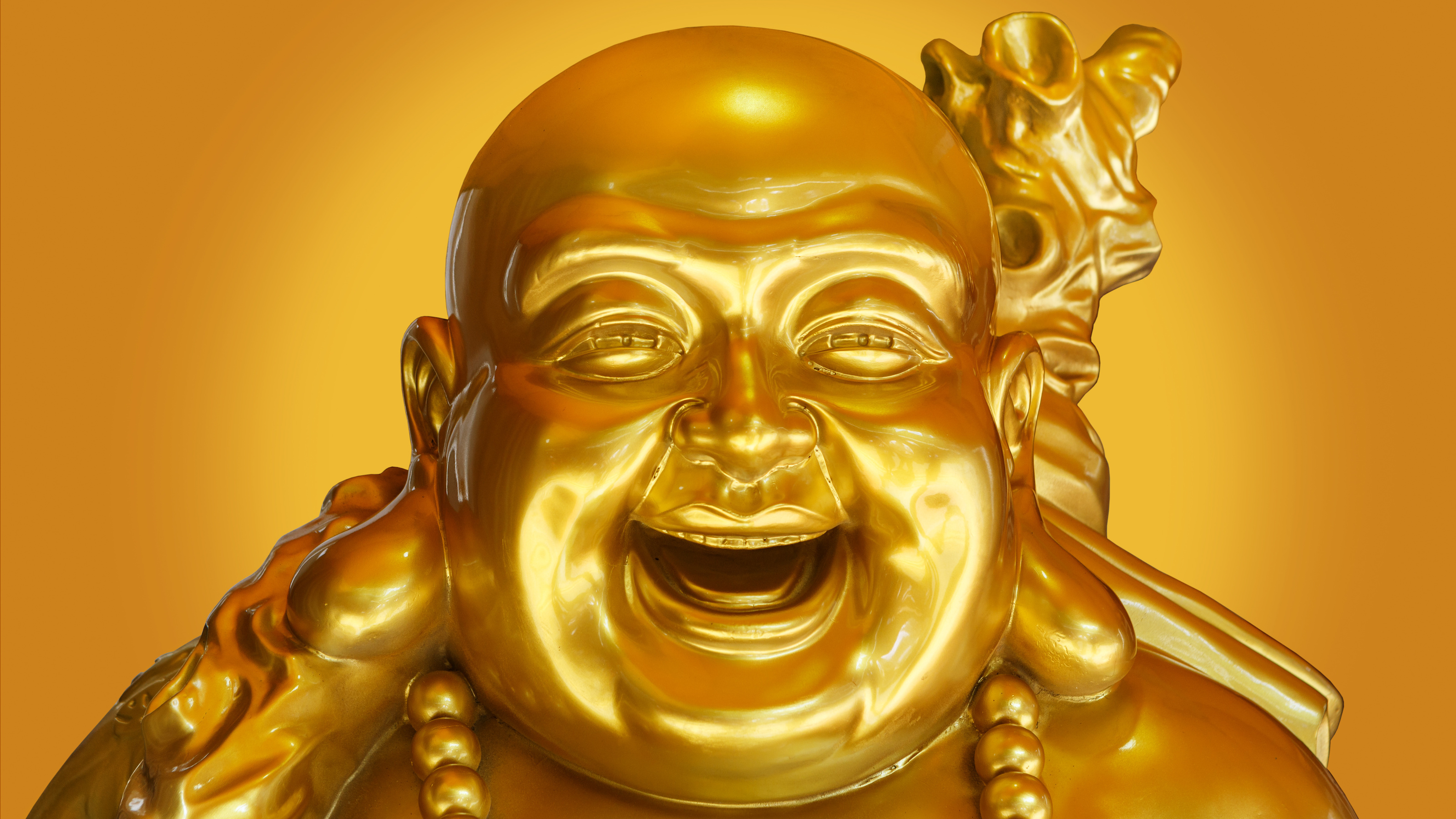 Laughing golden Buddha statue