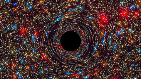 a black hole in the center of a space filled with stars.