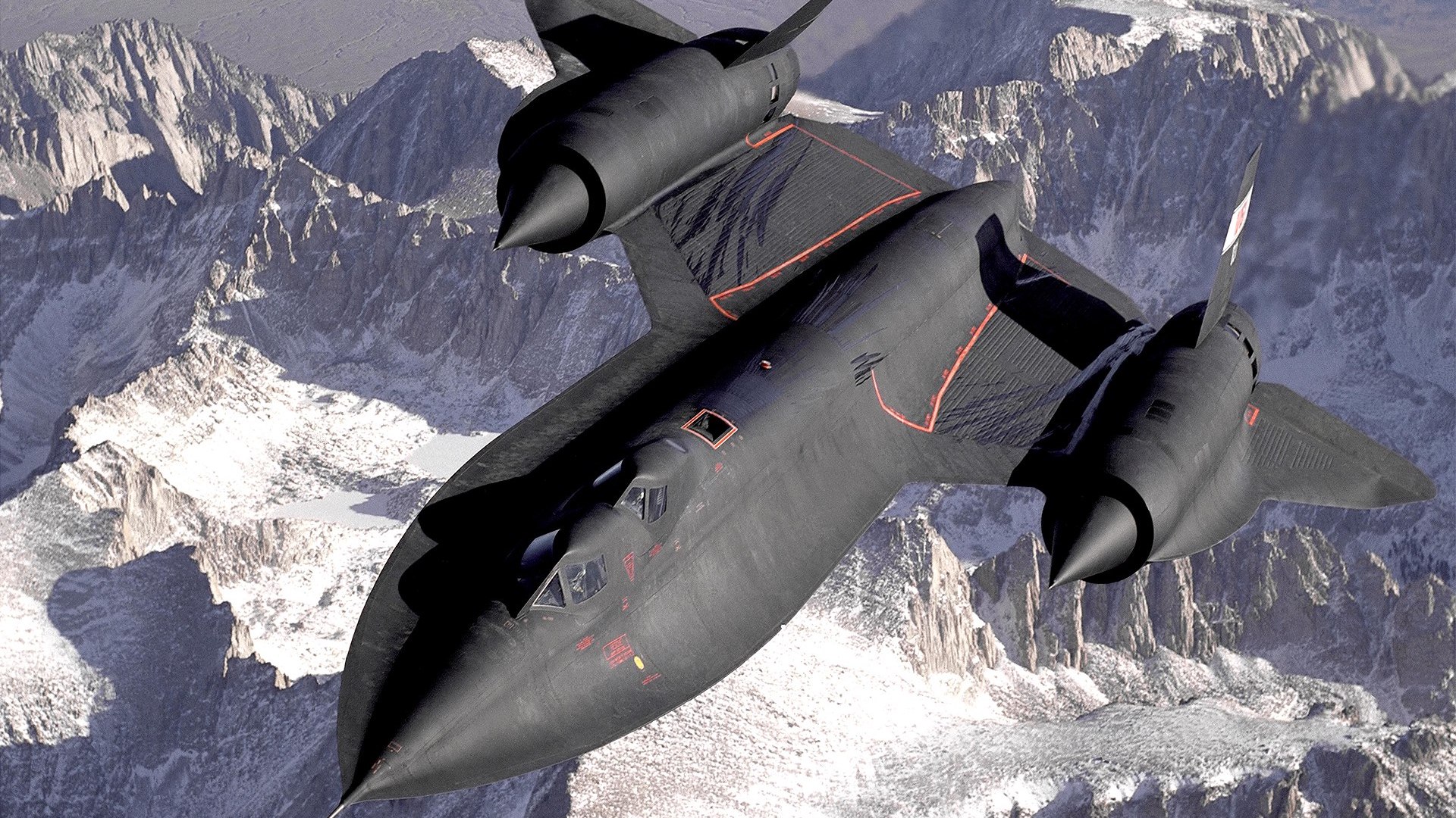 a fighter jet flying over a mountain range.