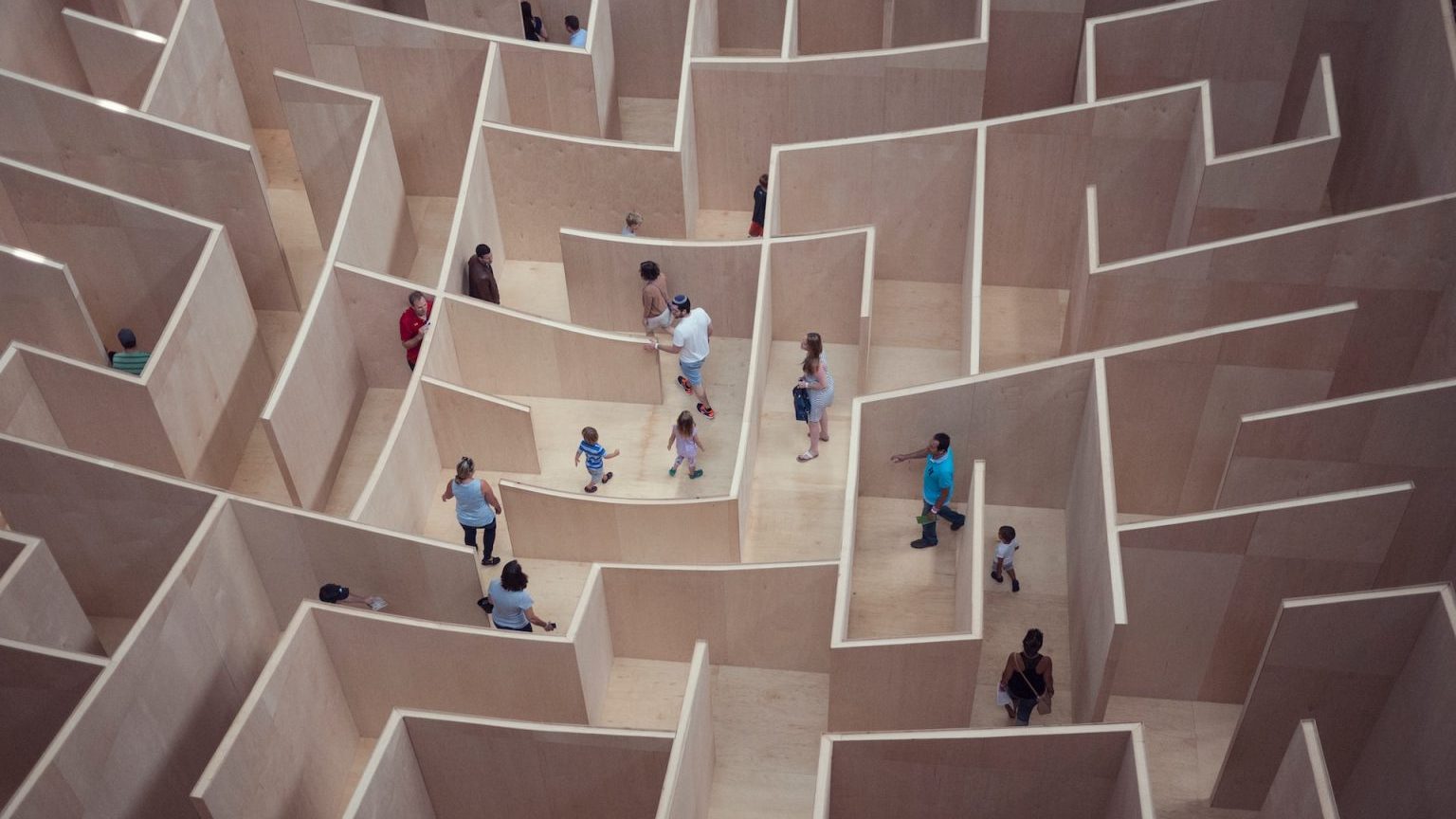 a group of people standing inside of a maze.