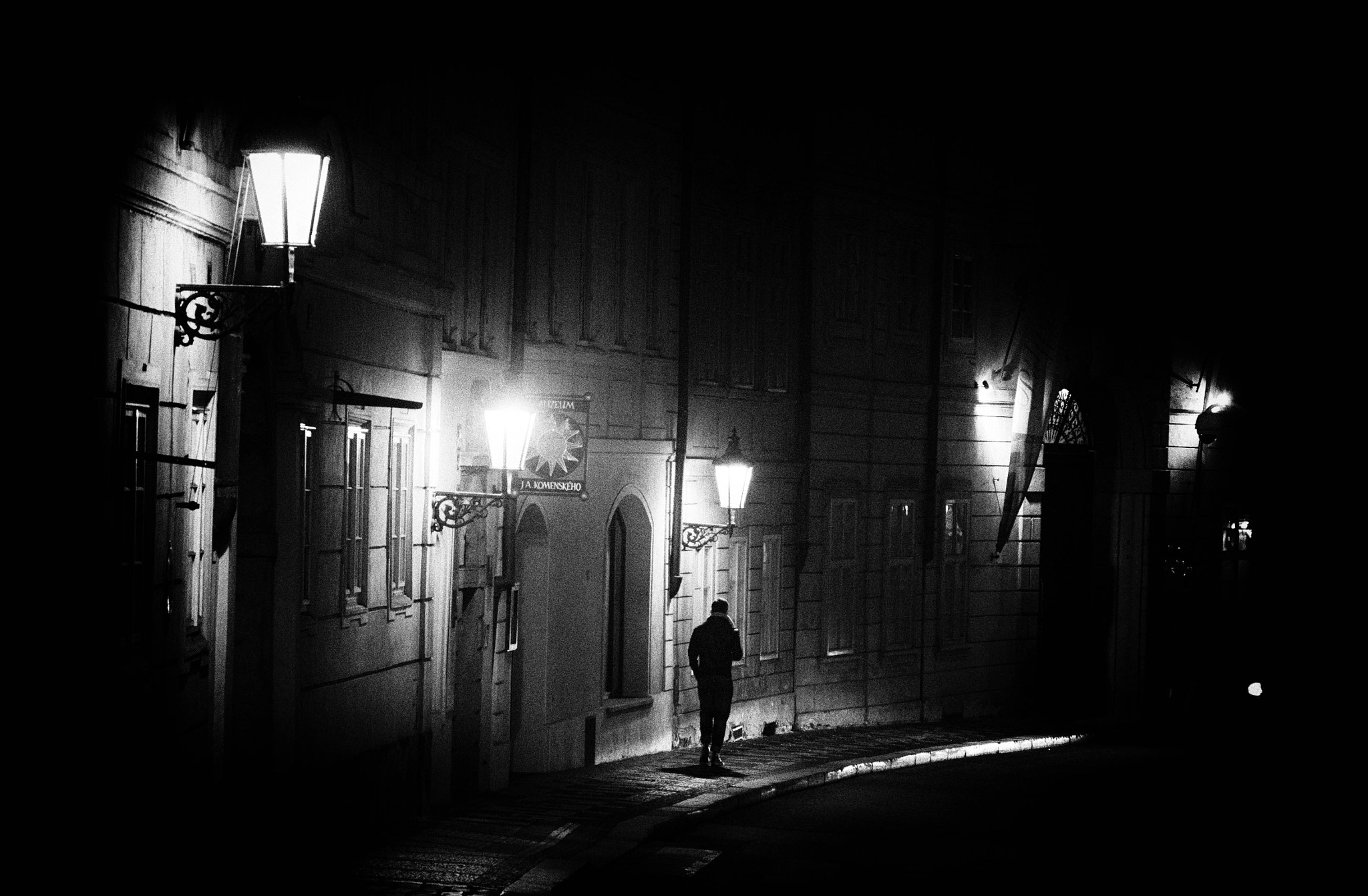 a person standing on a street at night.