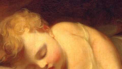 Close-up of a classical painting depicting a sleeping child with curly blonde hair, rosy cheeks, and closed eyes—lying on their side against a dark background, capturing the peaceful transition between wakefulness and consciousness.