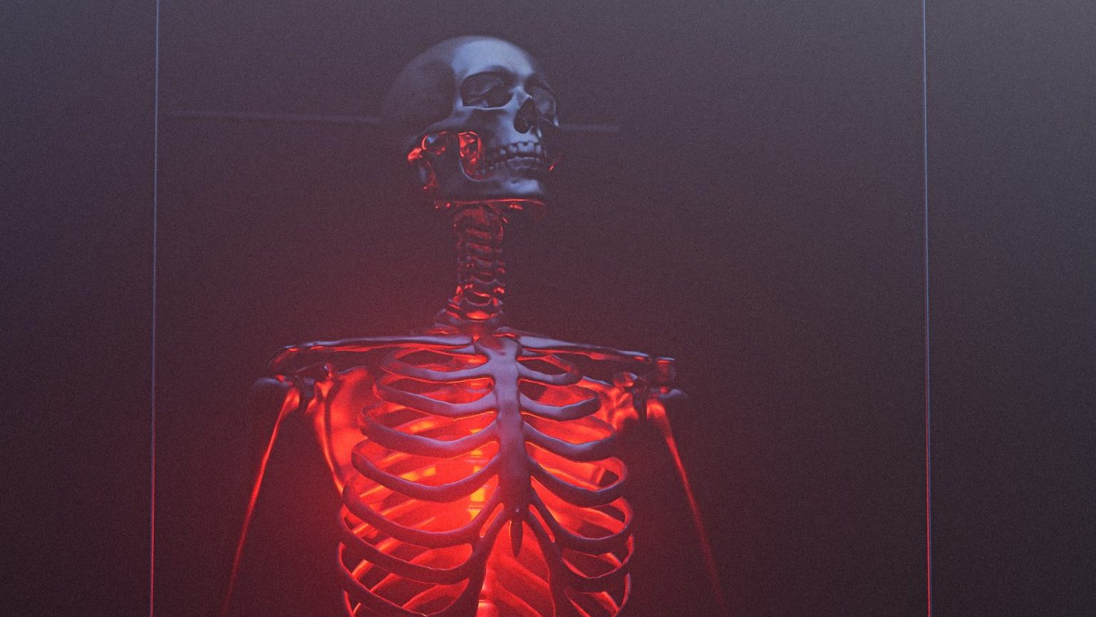 a skeleton is shown in a red light.