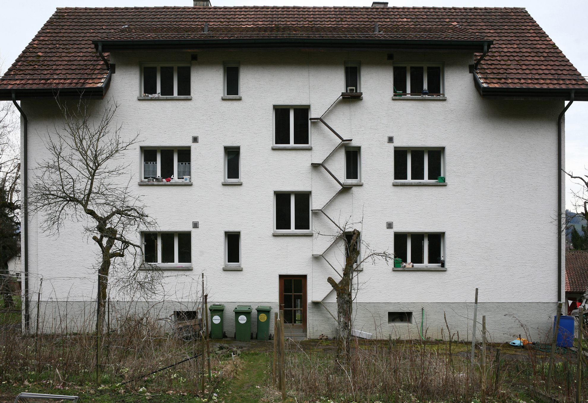 a tall white building with lots of windows.