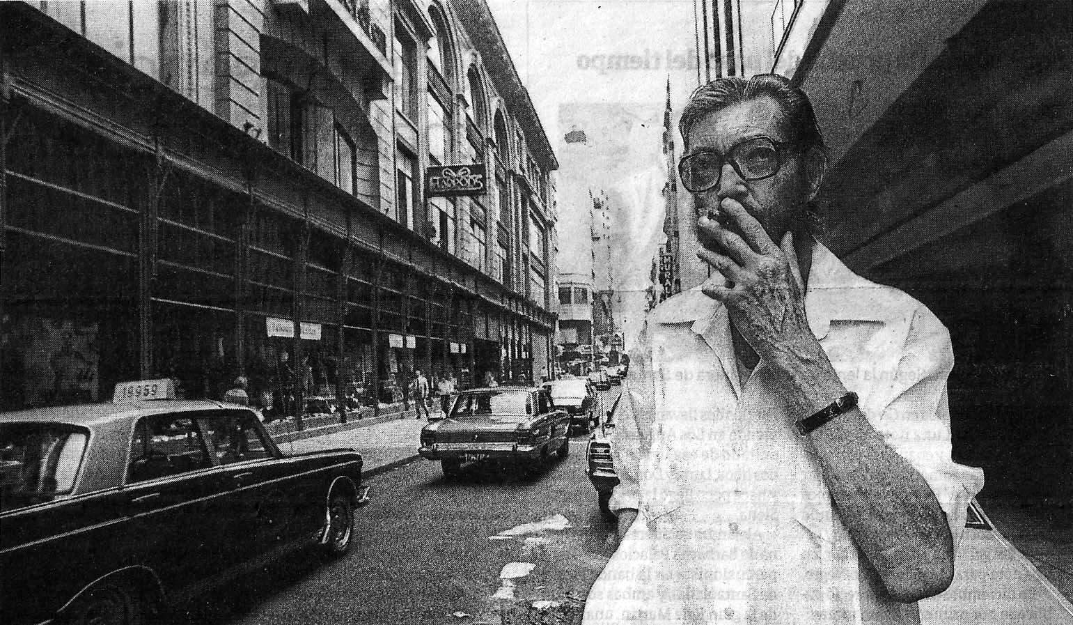 a black and white photo of a man on a city street.