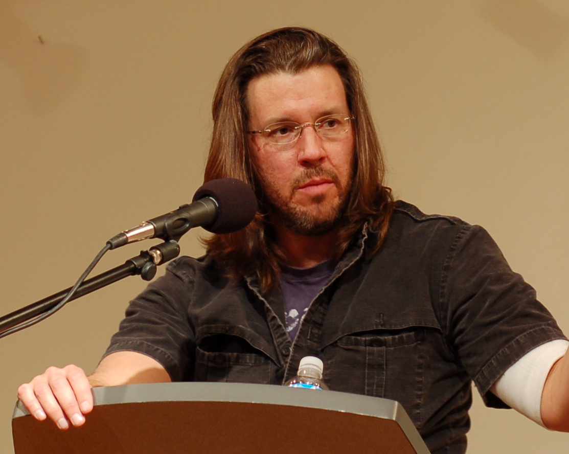 a man standing at a podium with a microphone.