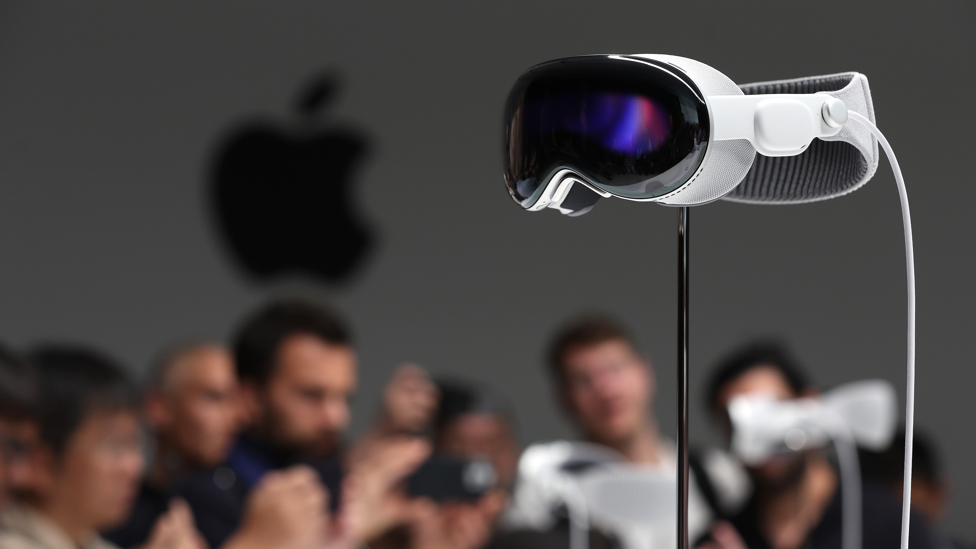 a group of people taking pictures of a projector.