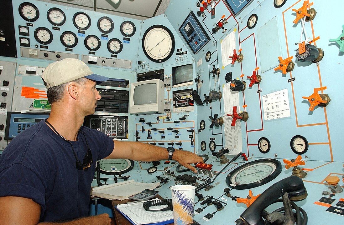 a saturation diver sitting in a control room.