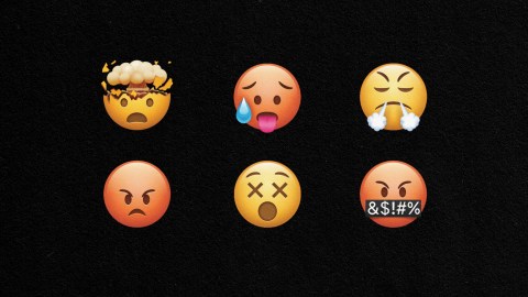 Outrage machine fueled by emojis with expressions on a black background.