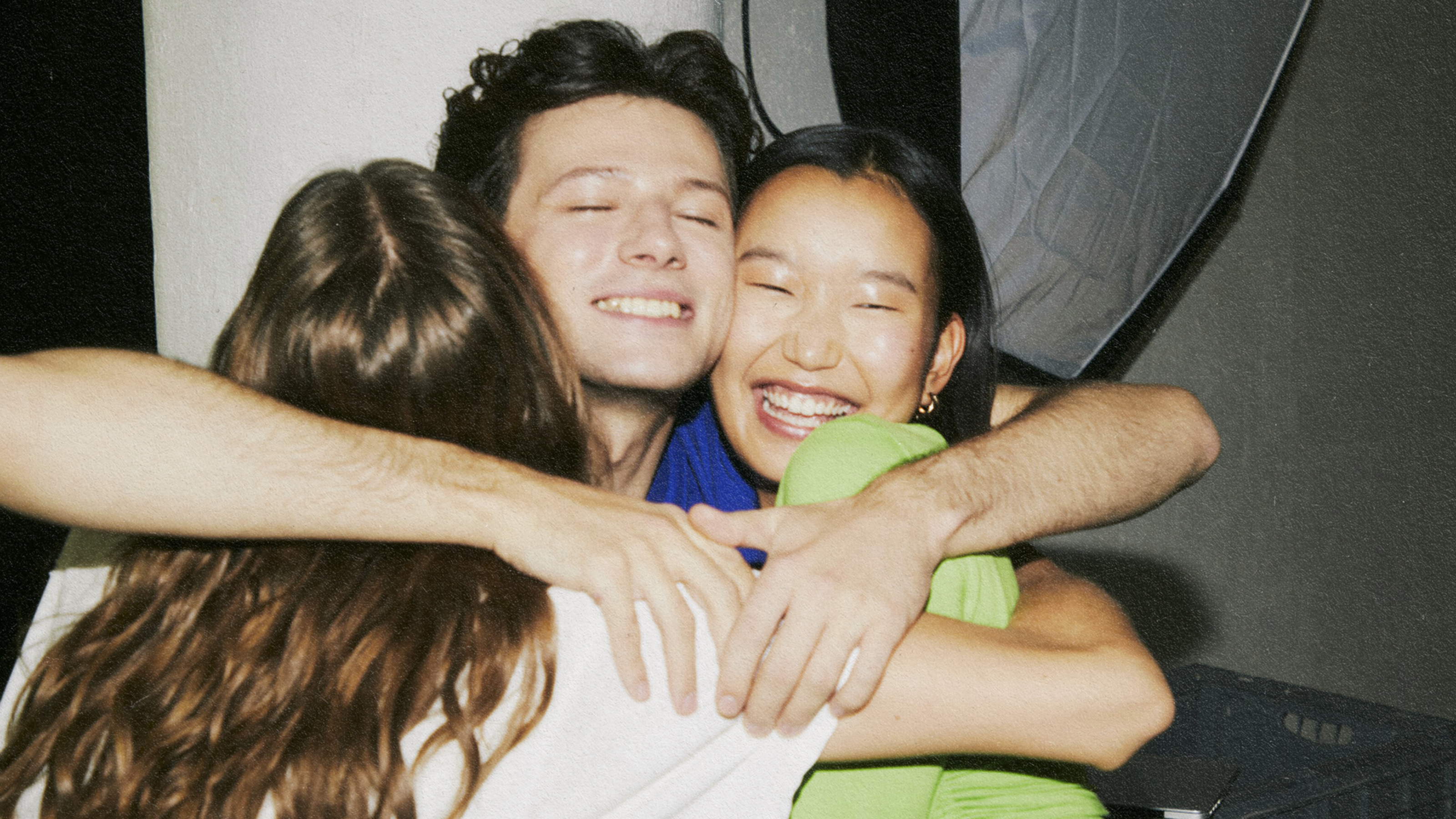 A group of friends hugging each other.