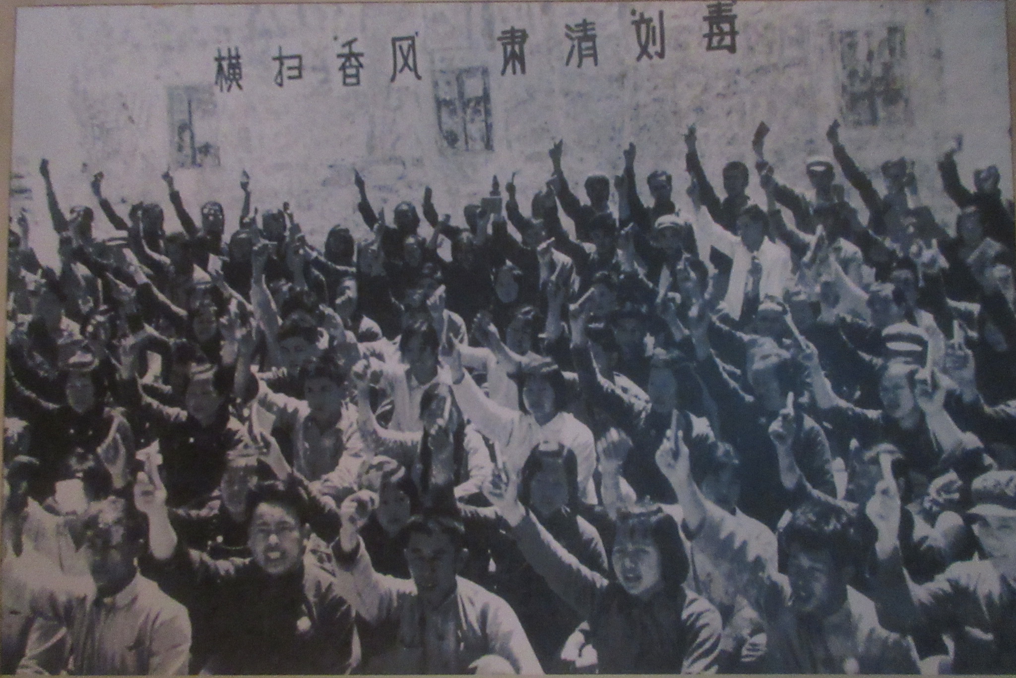 A black and white photo of a group of people raising their hands in China.