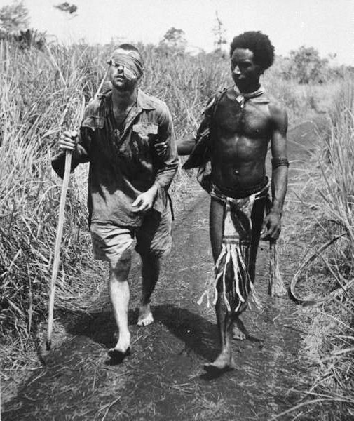 Two men walking down a path in Papua New Guinea.