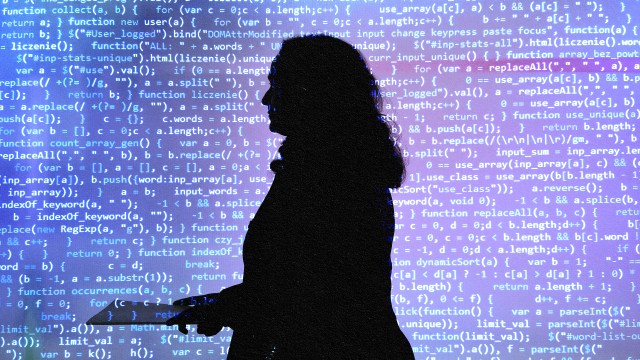 A silhouette of a woman standing in front of a computer screen, showcasing generative AI technology for business.
