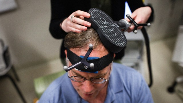 A man is undergoing a TMS treatment for depression.