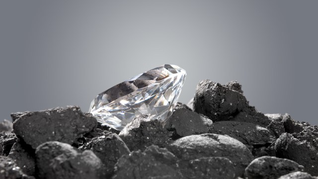 A diamond sits on top of a pile of rocks.