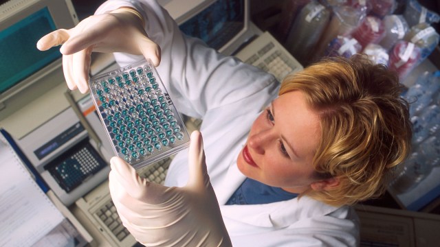 A woman wearing a lab coat researching non-hormonal birth control options.
