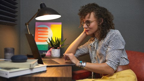 A woman making the best decisions at a desk with a laptop.
