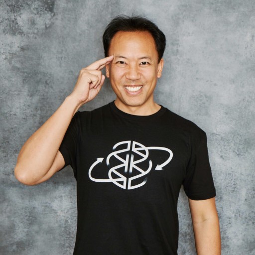 A man wearing a black t - shirt with a logo on it.