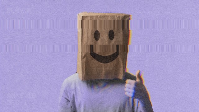 A person wearing a paper bag with a smiley face on it, exuding an air of happiness.