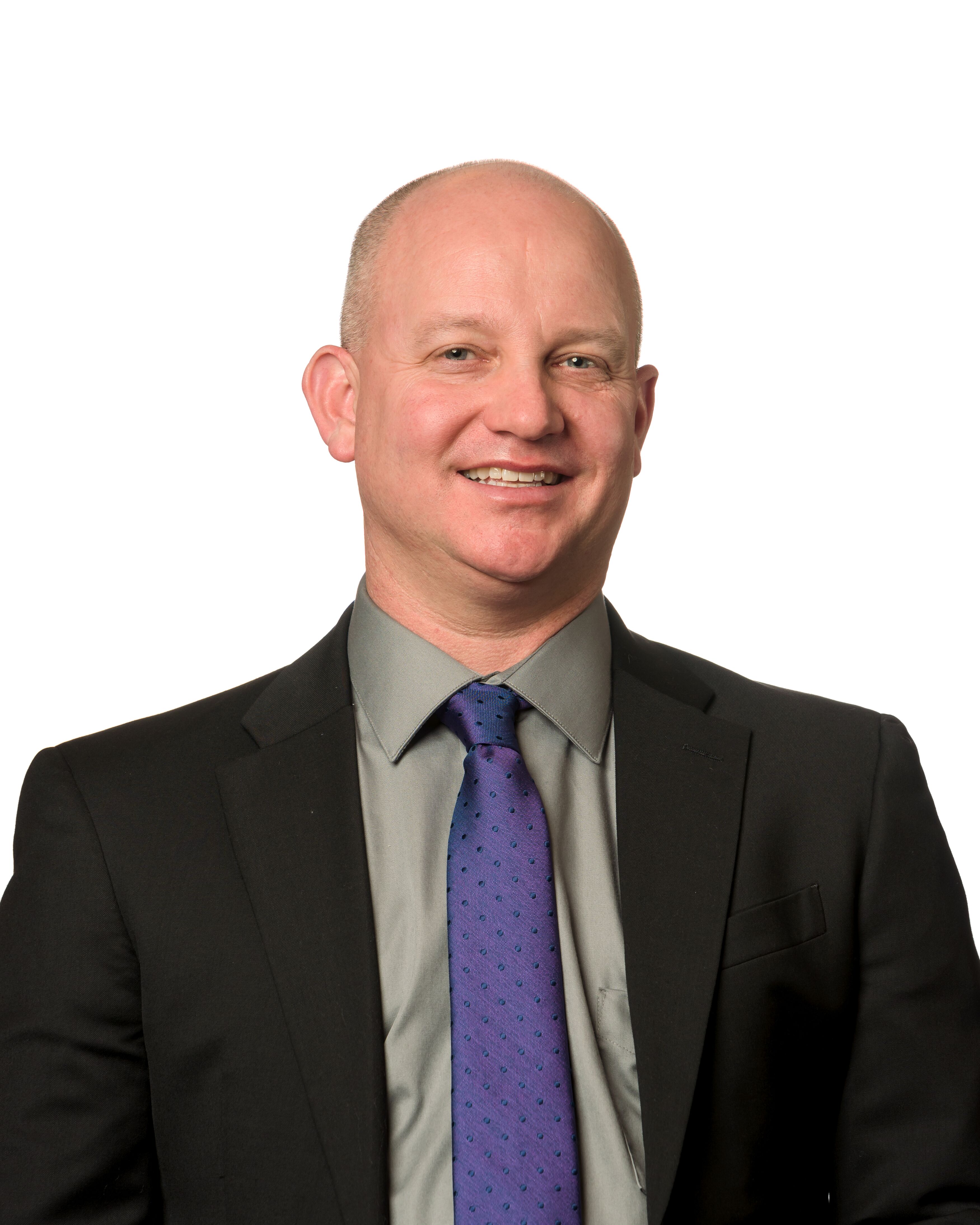 A bald man in a suit and tie.