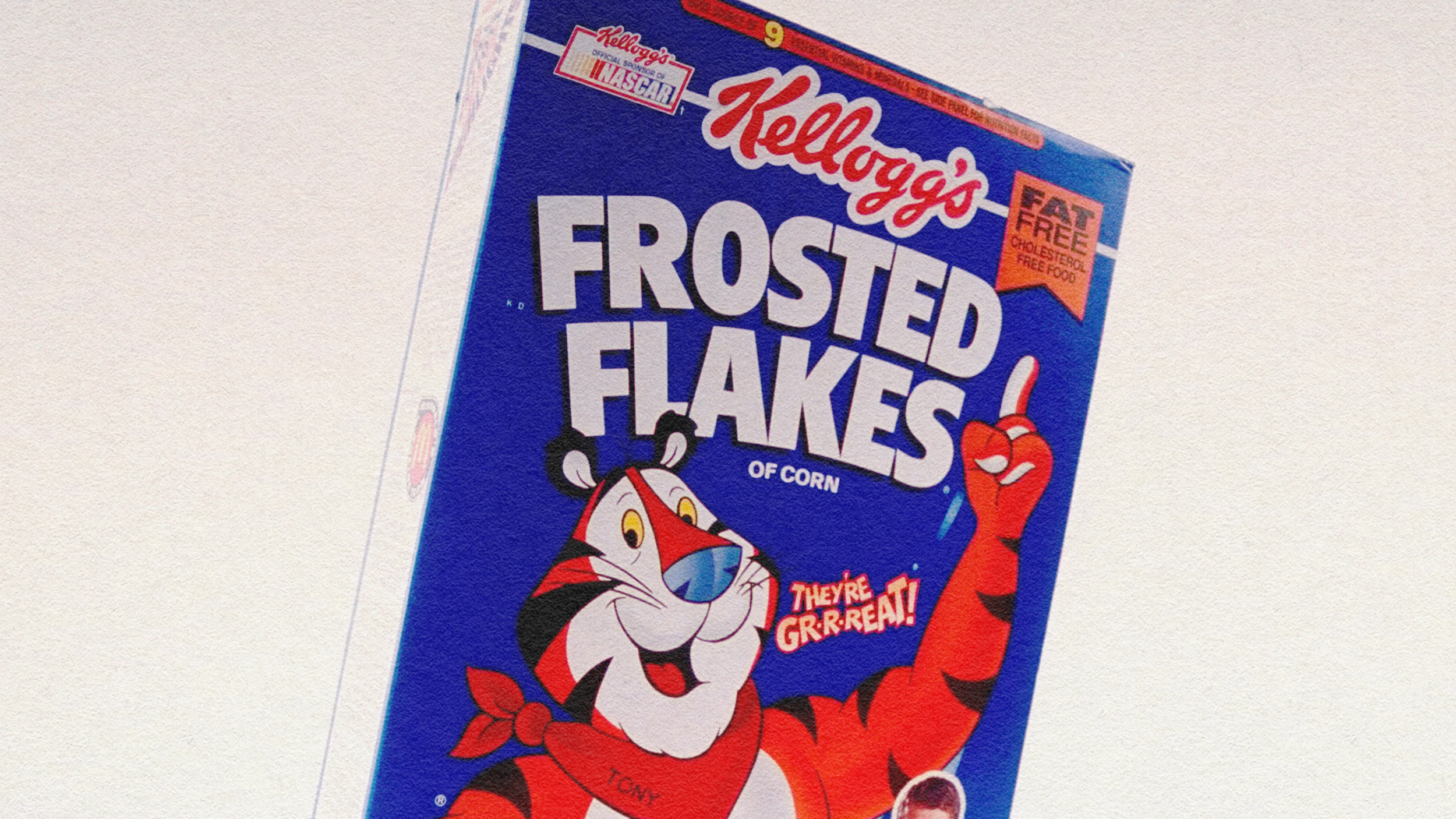 A box of processed kellogs frosted flakes.