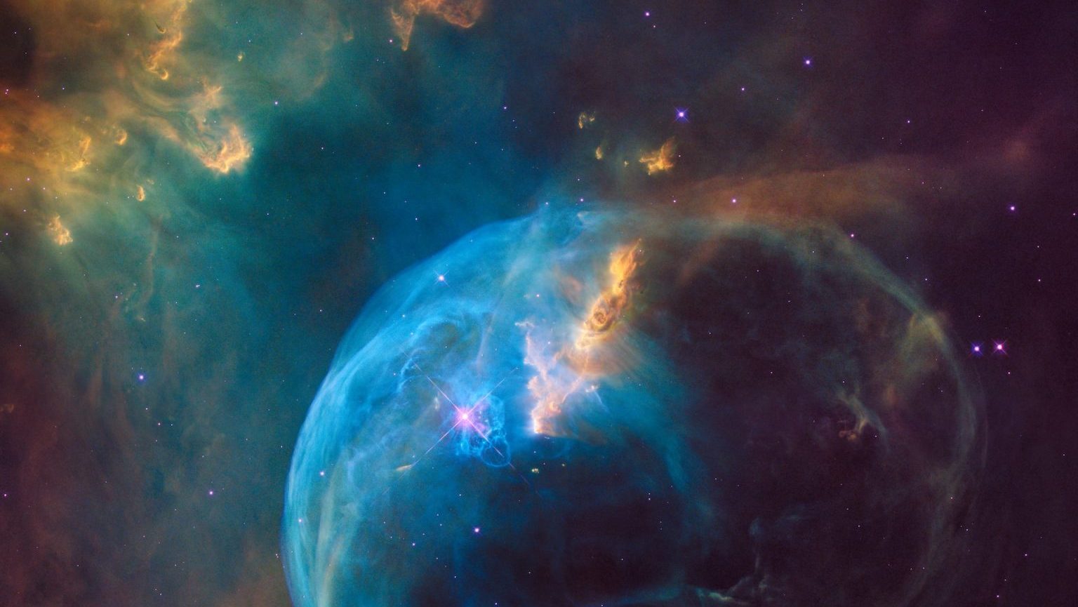 An image of a blue nebula in space.