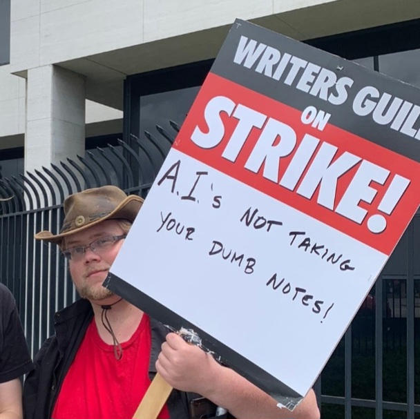 A group of people holding a sign that says SAG on strike against AI.