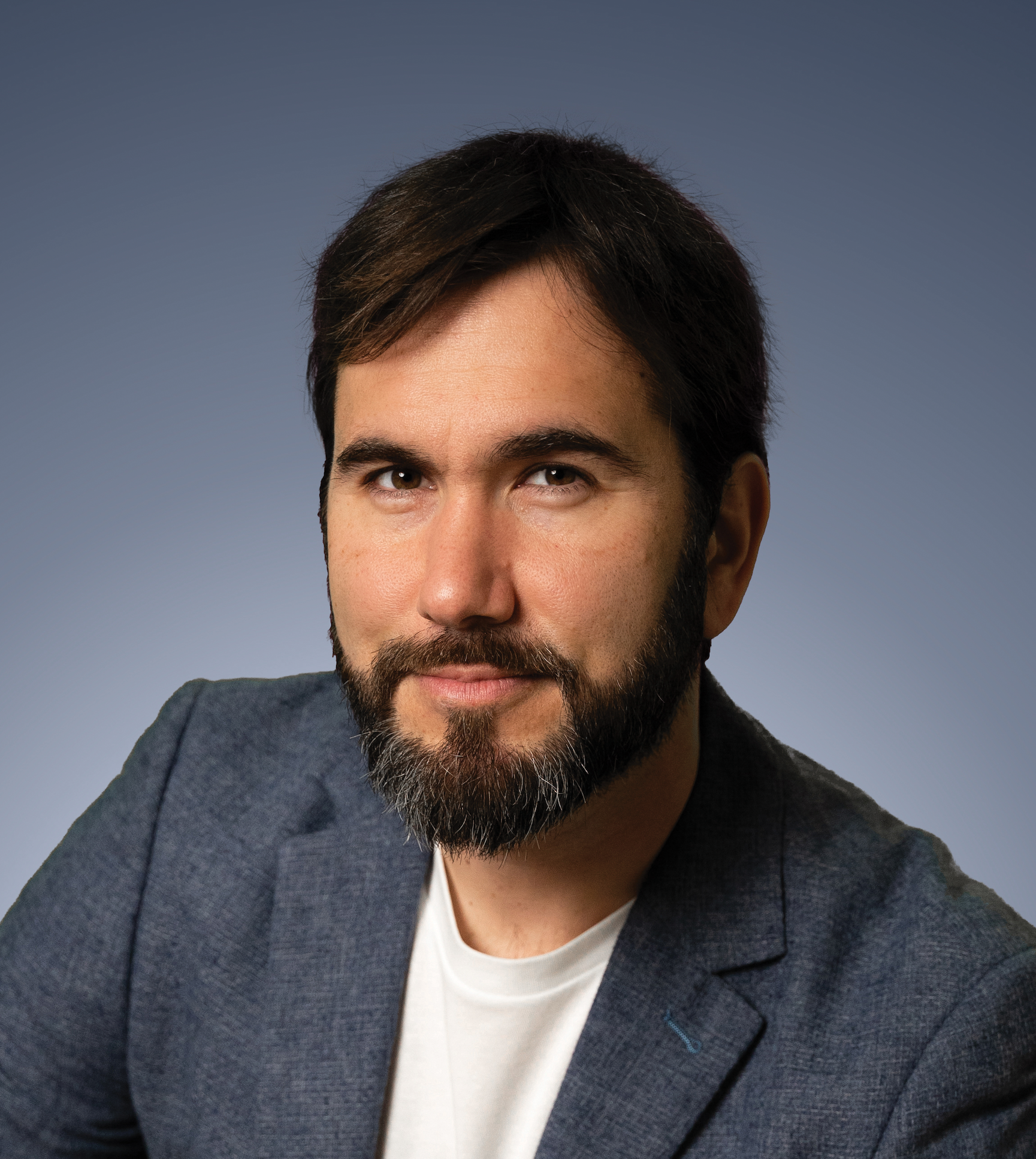 A man with a beard and a white shirt.