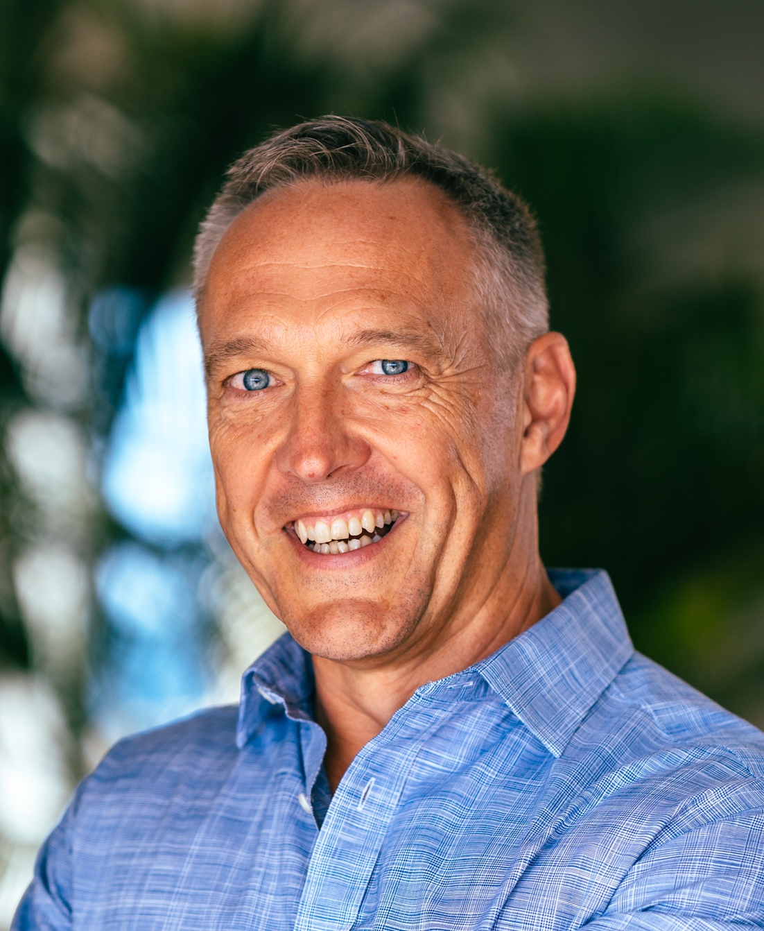 A smiling man in a blue shirt.