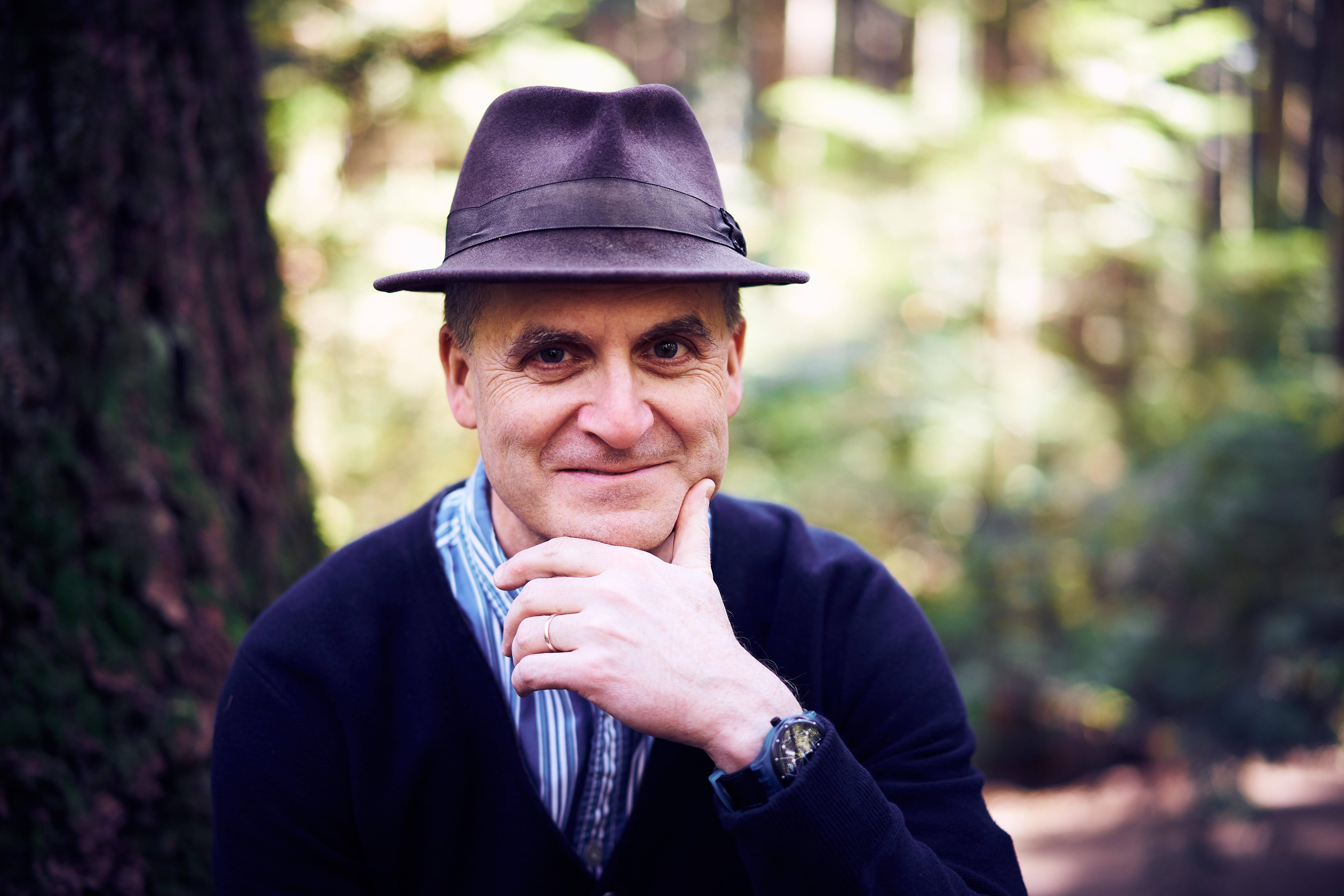 A man wearing a hat and a sweater.