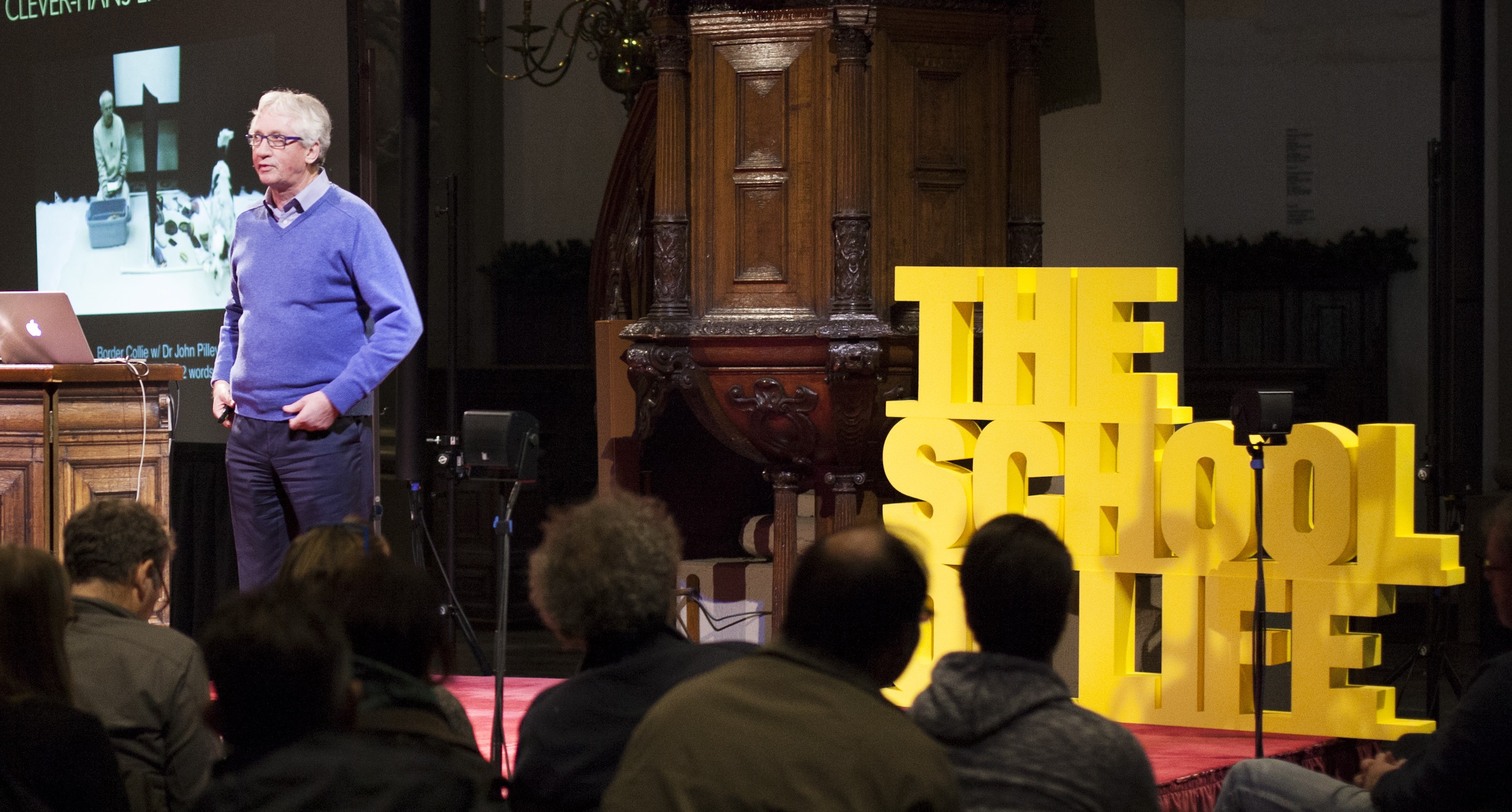 Man delivering a presentation at "the school of life" event.