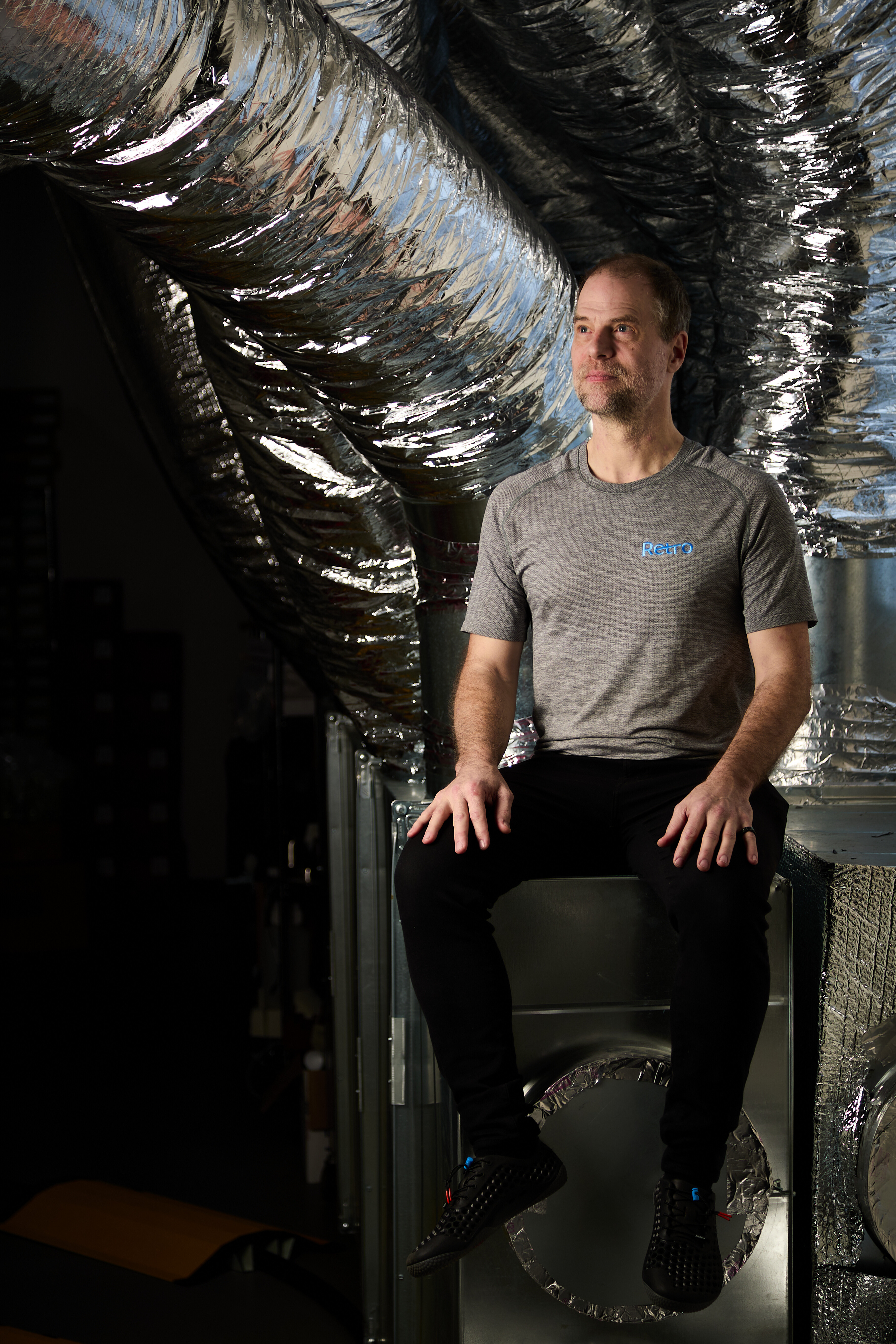 A man sitting on a metal box.