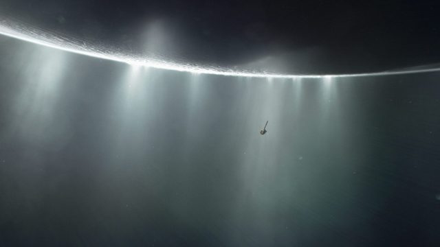 A spacecraft hovers near a bright ring of light in space, surrounded by misty rays and a vast, dark background.