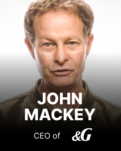 A man with short hair stands against a plain background. Text over the image reads, "John Mackey, CEO of &G.