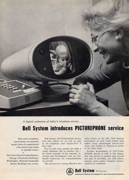 An elderly woman looks at a display screen on a Picturephone while holding a baby. The Picturephone shows a person on the other end. A headline reads: "Bell System introduces PICTUREPHONE service.