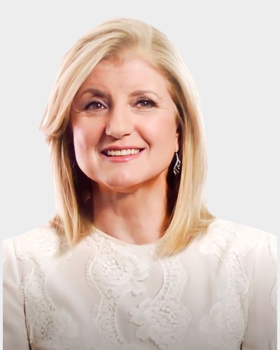 A woman with shoulder-length blonde hair is smiling. She is wearing a white lace top and earrings, set against a plain white background.