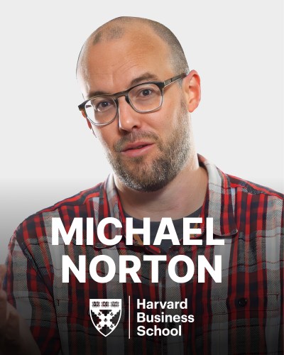 A person wearing glasses and a red plaid shirt is shown in a close-up shot with the text "Michael Norton" and "Harvard Business School" overlaying the image.