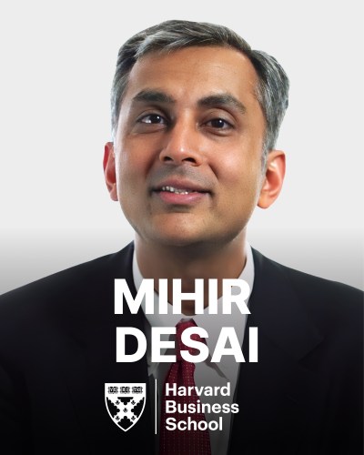 A person in a suit and tie is shown against a plain background. The text reads, "Mihir Desai, Harvard Business School," with the school's logo displayed below the name.