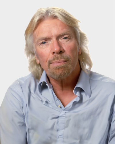 A man with shoulder-length blond hair and a light beard, wearing a light blue collared shirt, looks directly ahead against a plain white background.