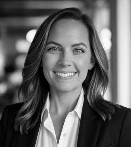 A woman with shoulder-length hair, wearing a white shirt and dark blazer, smiles in a professional headshot.