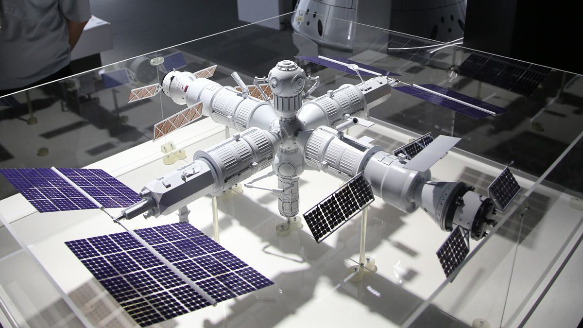 A detailed model of a space station featuring multiple modules and solar panels on display.