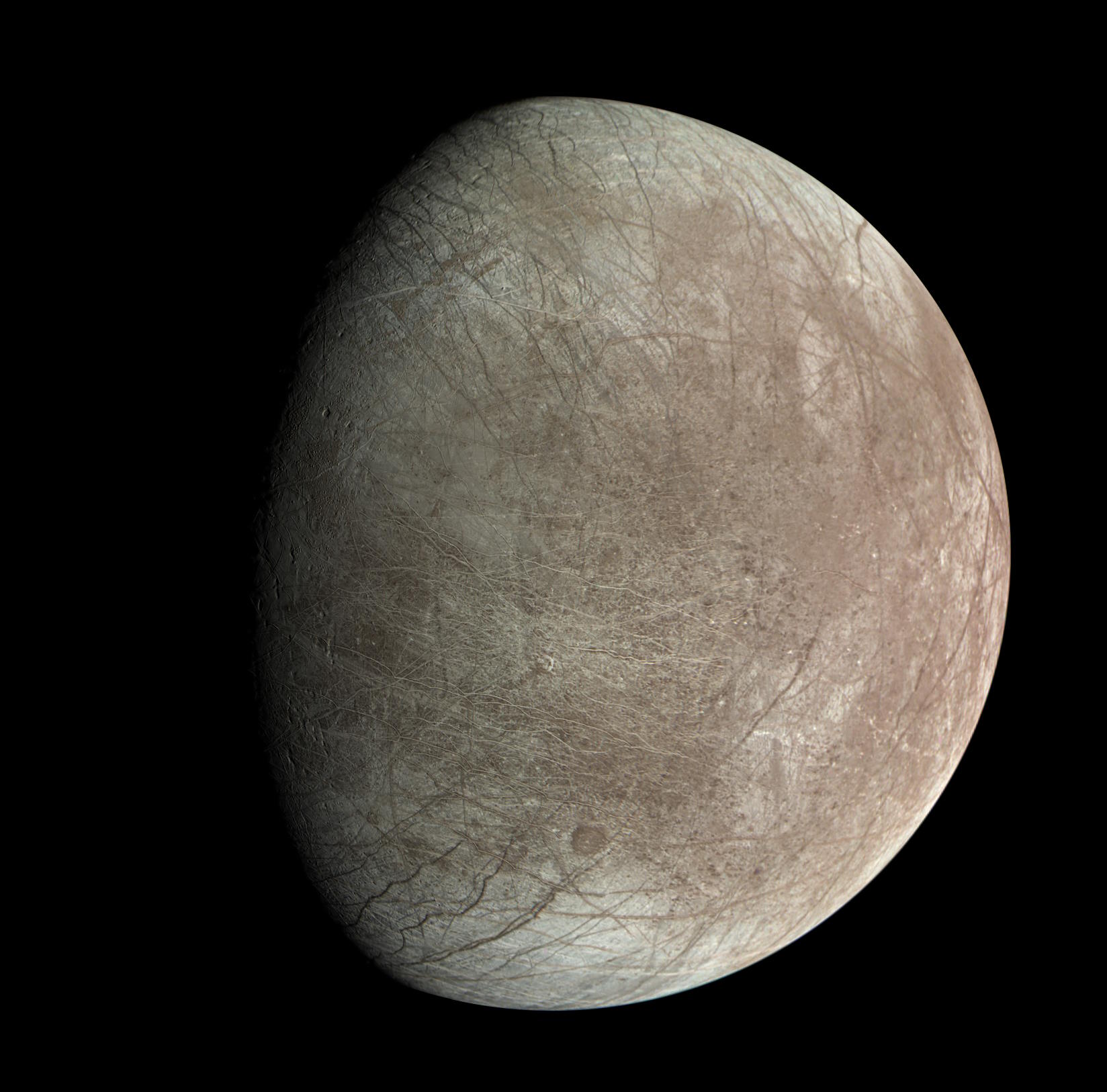 A close-up view of a gray, rocky celestial body with visible surface cracks hints at the mysteries that may await NASA's Europa Clipper mission, exploring the potential for alien life against the vast black backdrop of space.