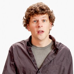 A person with curly hair wears a gray shirt and dark jacket, standing in front of a plain background with a "BT+" logo in the top right corner.